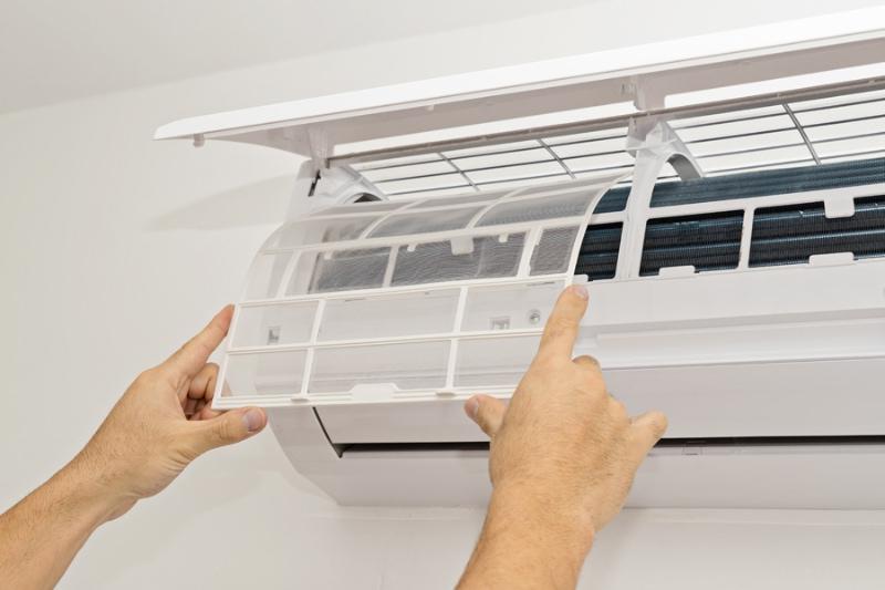 What Maintenance Is Needed for a Ductless System? Changing the filter in the air conditioner. The concept of safe and healthy housing.